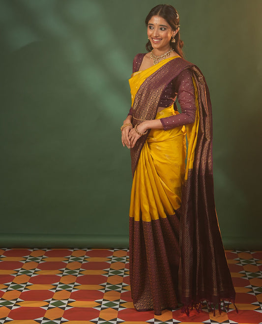 Yellow floral zari buttas woven skrit-border-style woven silk saree, contrast annam chakram butta enclosed checked border, and zari-rich jaal pallu