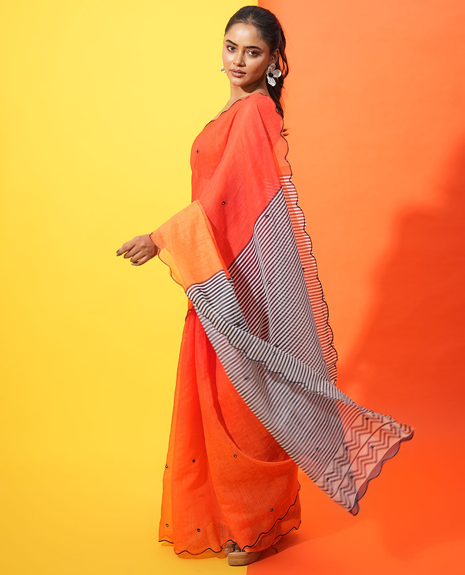 Red-Orange Linen Cotton Saree, Bedecked with Ombre-Style Dyed with Mirror Work Across Its Body, Subtly Sparkled Scallop Thread Border, Pallu Steeped with Stripes and Mirror Work, and Paired with a Contrast Vertical Stripes Printed Blouse