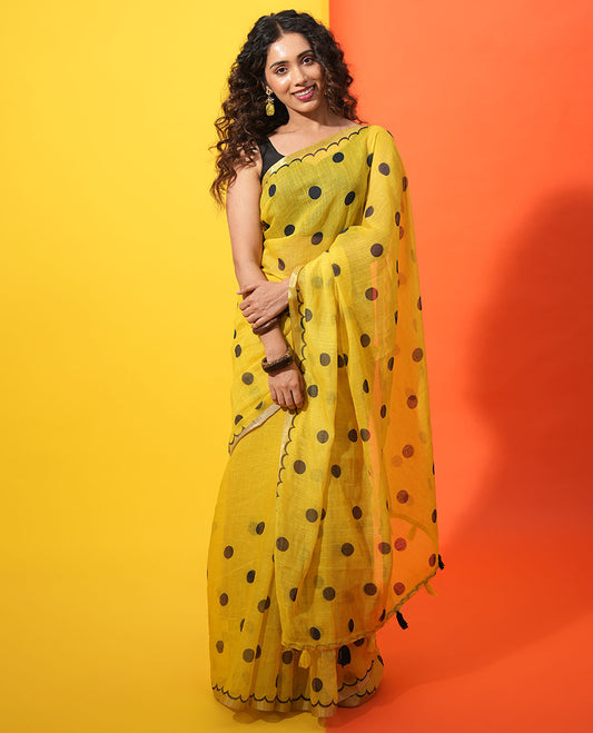 Yellow Linen Cotton Saree, Beautified with Polka Dots All Over Its Body, Subtle Piping Border, Self-Pallu, and Paired with a Floral Printed Matching Blouse
