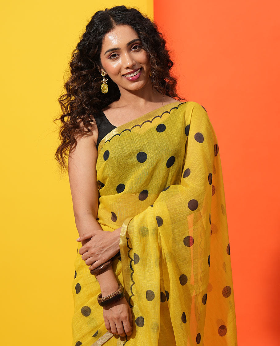 Yellow Linen Cotton Saree, Beautified with Polka Dots All Over Its Body, Subtle Piping Border, Self-Pallu, and Paired with a Floral Printed Matching Blouse