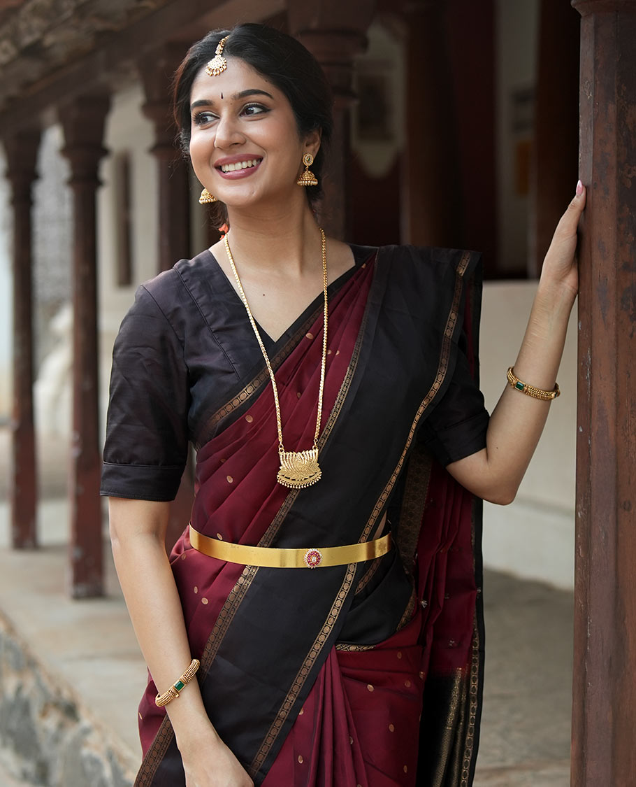 Maroon Poun Buttas Vasundhara Silk Saree, Contrast Rettai Pettu Border of Rekku, Neli, and Rudraksham Designs, and Zari-Rich Intricate Pallu