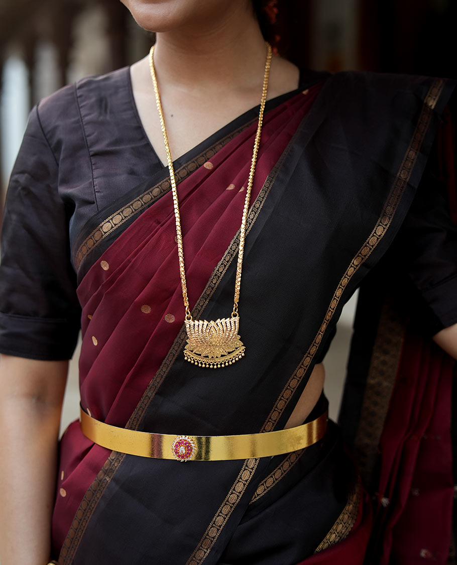 Maroon Poun Buttas Vasundhara Silk Saree, Contrast Rettai Pettu Border of Rekku, Neli, and Rudraksham Designs, and Zari-Rich Intricate Pallu