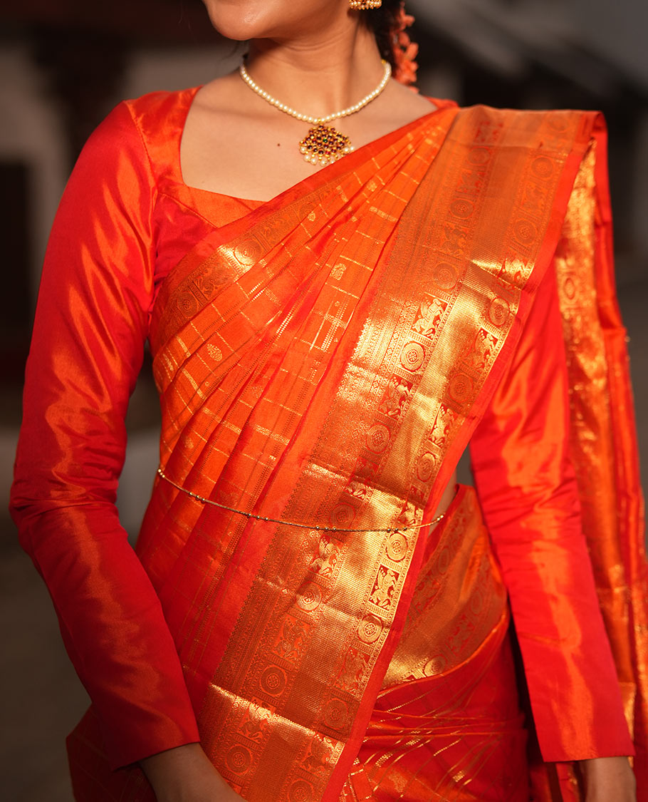 Dazzling Zari Butta Enclosed in a Checked Silk Saree, Zari Border of Kuthirai and Chakram Designs, and Intricately Zari-Woven Pallu