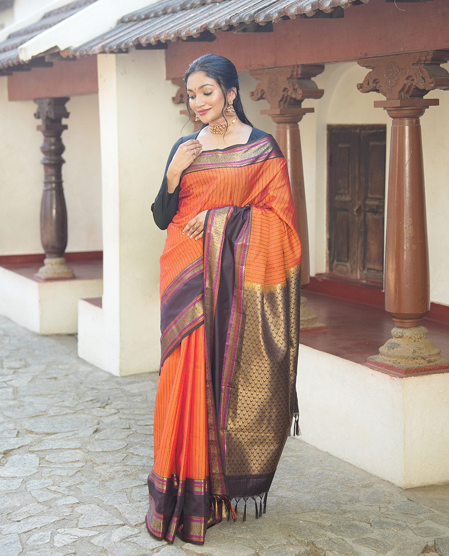 Orange Vasundhara Lite Silk Saree, Subtly Detailed with Stripes, Complemented by a Contrast Rettai Pettu Border of Salngai, Cross Kamalam, Muthu, Kathir, Diamond, and Arumbu Manga Designs, Grand Jaal Pallu, and Paired with a Contrast Blouse