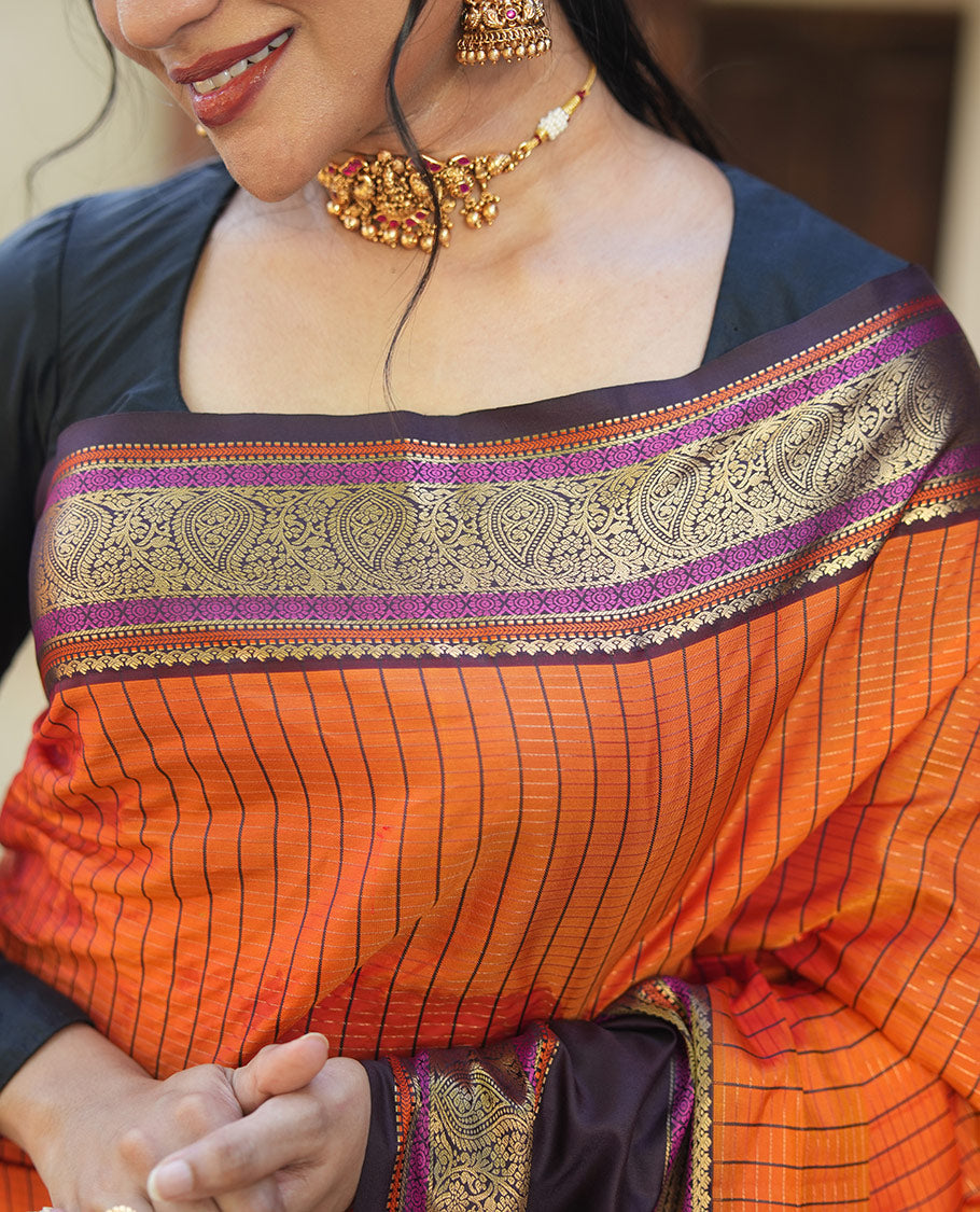 Orange Vasundhara Lite Silk Saree, Subtly Detailed with Stripes, Complemented by a Contrast Rettai Pettu Border of Salngai, Cross Kamalam, Muthu, Kathir, Diamond, and Arumbu Manga Designs, Grand Jaal Pallu, and Paired with a Contrast Blouse