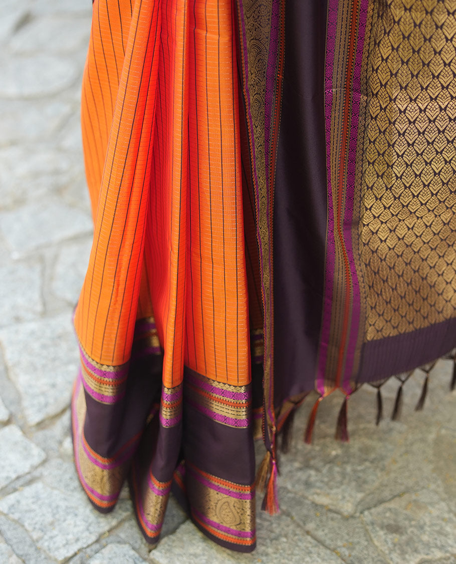Orange Vasundhara Lite Silk Saree, Subtly Detailed with Stripes, Complemented by a Contrast Rettai Pettu Border of Salngai, Cross Kamalam, Muthu, Kathir, Diamond, and Arumbu Manga Designs, Grand Jaal Pallu, and Paired with a Contrast Blouse
