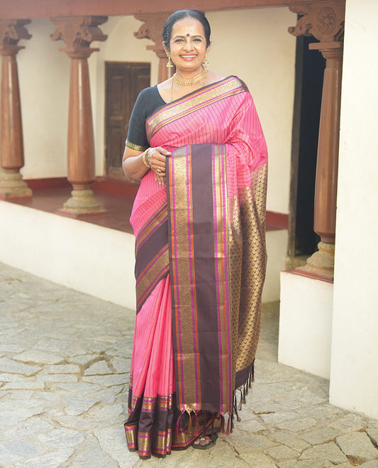 Pink Vasundhara Lite Silk Saree, Subtly Detailed with Thread and Zari Stripes, Complemented by Contrast Rettai Pettu Border of Salngai, Cross Kamalam, Muthu, Kathir, Diamond, and Arumbu Manga Designs, Grand Jaal Pallu, and Paired with a Contrast Blouse