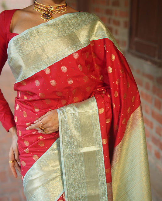 Red BudgetSilk Saree, Spotlighted with Zari Buttas All Over Its Body, Complemented by a Contrast Border of Banaras, Muthu, Kodi Visiry and Kodi Manga Designs, Pallu Steeped with Kodi Manga Designs, and Paired with a Contrast Blouse