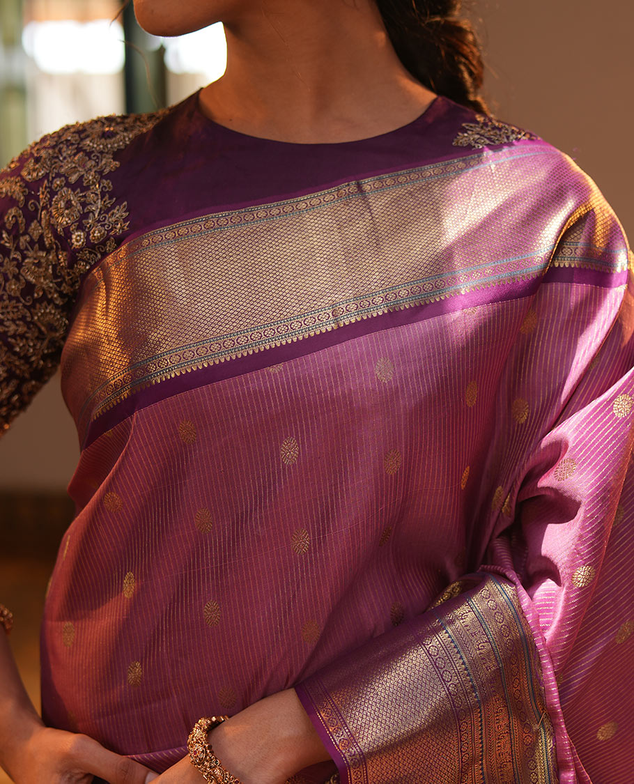 Pink Vasundhara Silk Saree, Elevated with Zari Stripes and Chakram Buttas All Over Its Body, Complemented by a Contrast Border of Rekku, Muthu, Kamalam and Mayil Kann Designs, Grand Geometric Patterned Pallu, and Paired with a Contrast Blouse