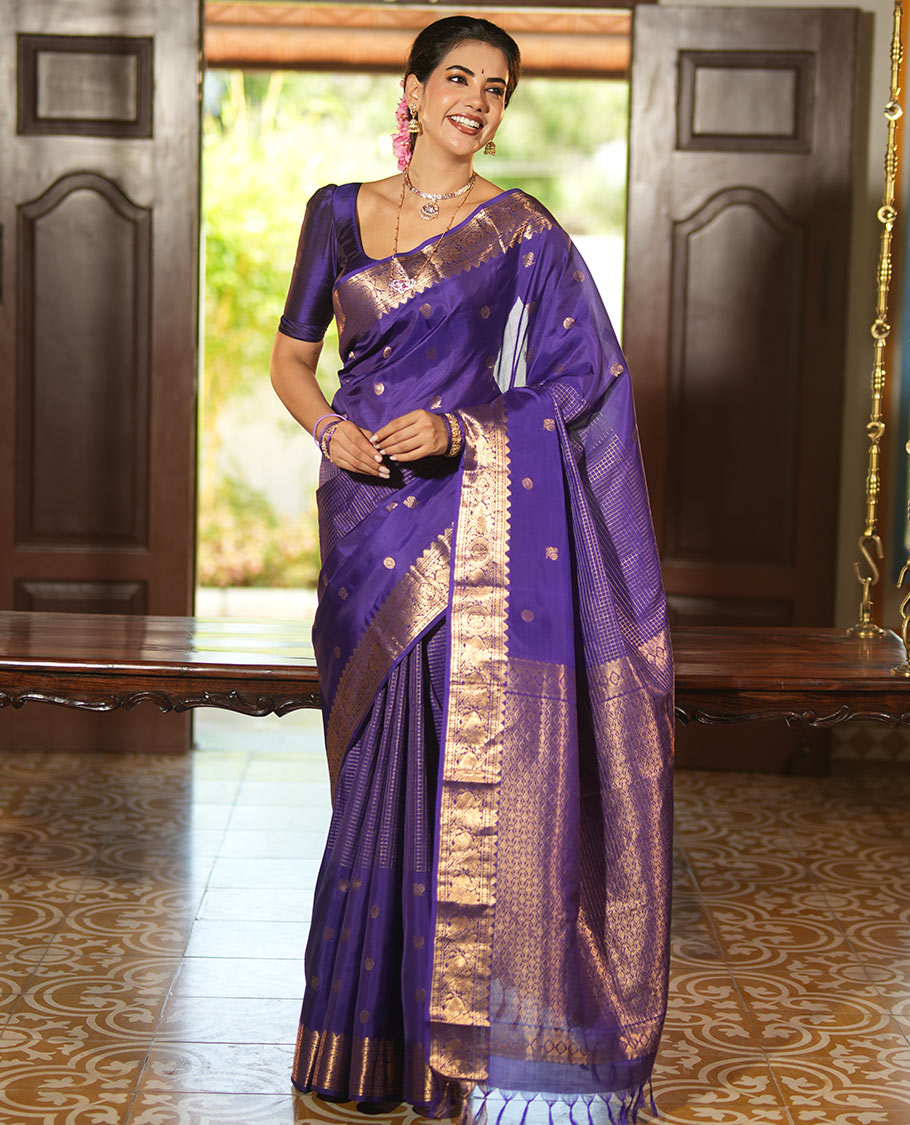 Violet Vasundhara Lite Silk Mix Saree, Artfully Detailed with Mayil-Chakram Buttas and Zari Checks All Over Its Body, Highlighted by a Zari Border of Thazampoo Rekkum, Paisa, Mayil, and Chakram Designs, a Grand Pallu, and Paired with a Matching Blouse