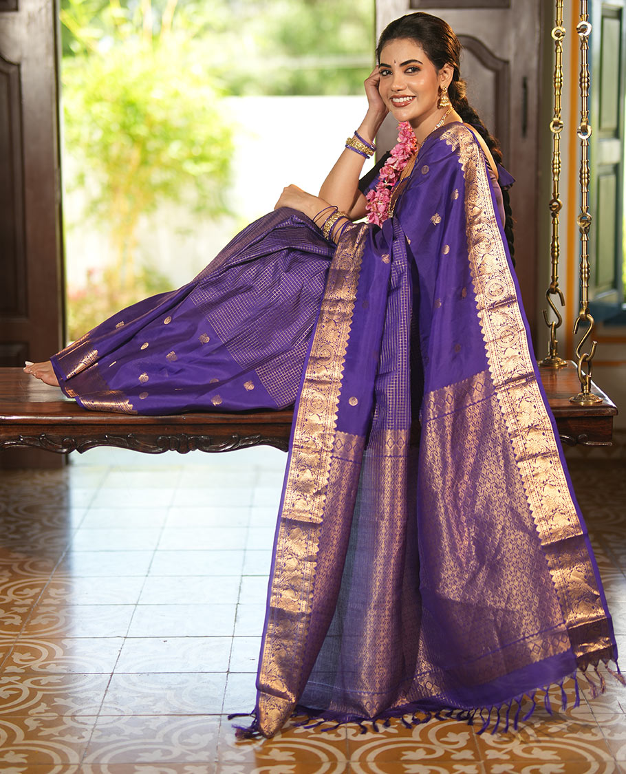 Violet Vasundhara Lite Silk Mix Saree, Artfully Detailed with Mayil-Chakram Buttas and Zari Checks All Over Its Body, Highlighted by a Zari Border of Thazampoo Rekkum, Paisa, Mayil, and Chakram Designs, a Grand Pallu, and Paired with a Matching Blouse