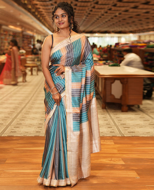 Blue Semi-Tussar Saree Colorfully Printed with Zig-Zag Stripes, Subtly Woven with a Resham Thread Temple Border, Featuring a Heathered Pallu, Paired with a Contrast Striped Blouse