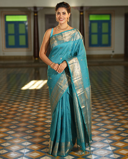 Blue Vasundhara Lite Silk Mix Saree, Richly Detailed with Zari Buttas and Zari Checks All Over Its Body, Highlighted by a Zari Border of Manga, Neli, Kamalam, Mayil, and Vanki Designs, Gleaming Intricately Designed Pallu, and Paired with a Matching Blouse