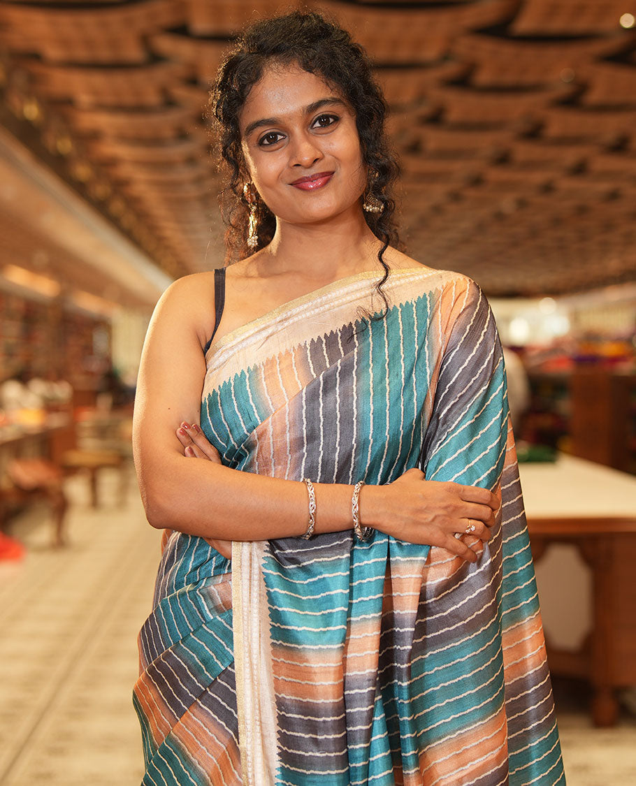 Blue Semi-Tussar Saree Colorfully Printed with Zig-Zag Stripes, Subtly Woven with a Resham Thread Temple Border, Featuring a Heathered Pallu, Paired with a Contrast Striped Blouse
