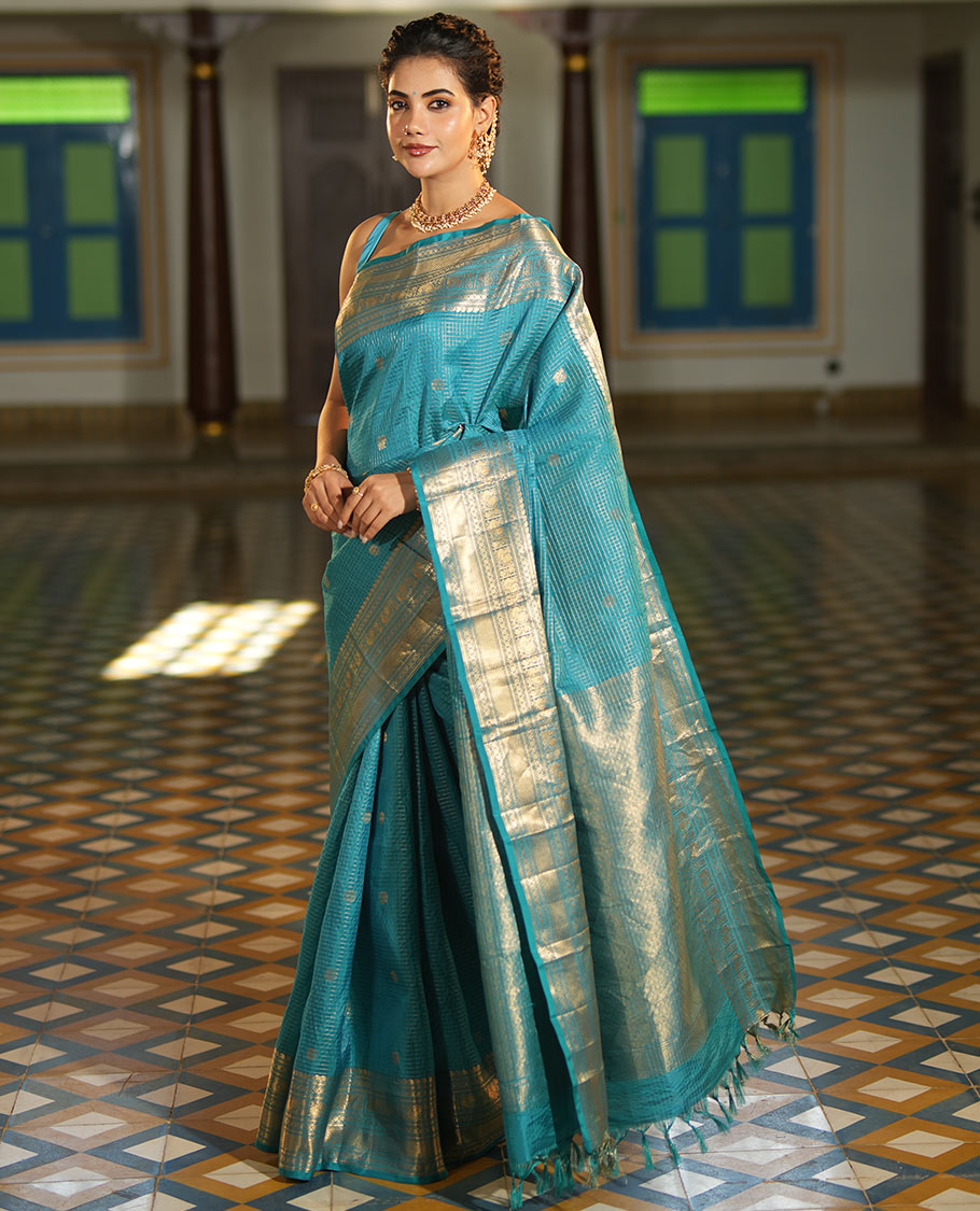 Blue Vasundhara Lite Silk Mix Saree, Richly Detailed with Zari Buttas and Zari Checks All Over Its Body, Highlighted by a Zari Border of Manga, Neli, Kamalam, Mayil, and Vanki Designs, Gleaming Intricately Designed Pallu, and Paired with a Matching Blouse