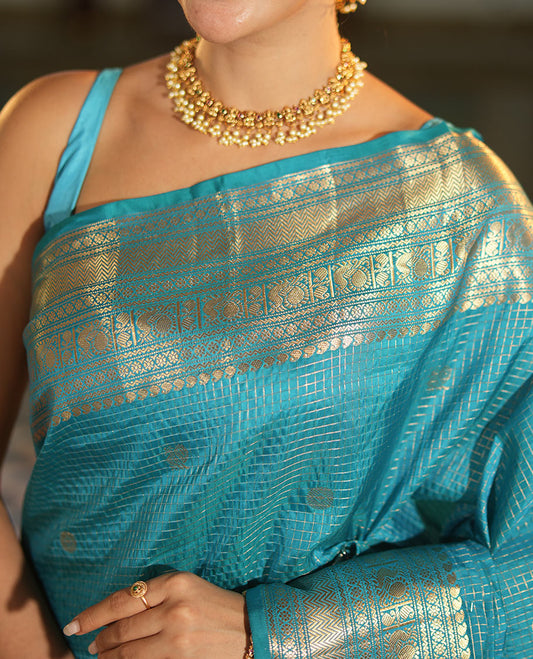 Blue Vasundhara Lite Silk Mix Saree, Richly Detailed with Zari Buttas and Zari Checks All Over Its Body, Highlighted by a Zari Border of Manga, Neli, Kamalam, Mayil, and Vanki Designs, Gleaming Intricately Designed Pallu, and Paired with a Matching Blouse