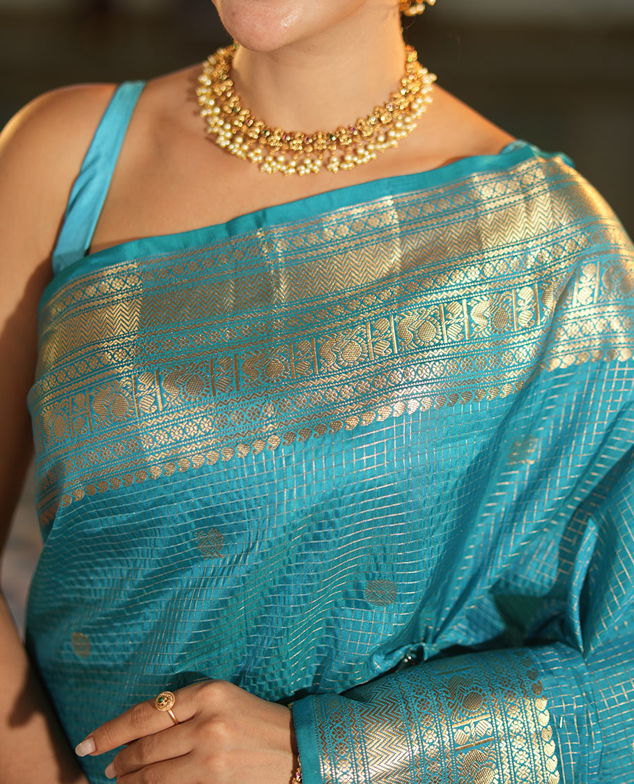 Blue Vasundhara Lite Silk Mix Saree, Richly Detailed with Zari Buttas and Zari Checks All Over Its Body, Highlighted by a Zari Border of Manga, Neli, Kamalam, Mayil, and Vanki Designs, Gleaming Intricately Designed Pallu, and Paired with a Matching Blouse