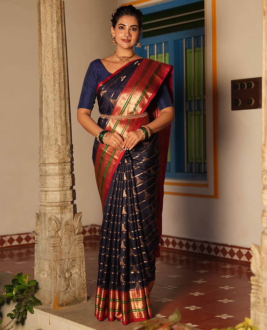 Blue Vasundhara Silk Saree, Accentuated with Zari Buttas and Stripes All Over Its Body, Complemented by a Contrast Border of Elephant, Mayil, and Chakram Designs, a Grand Pallu, and Paired with a Contrast Blouse