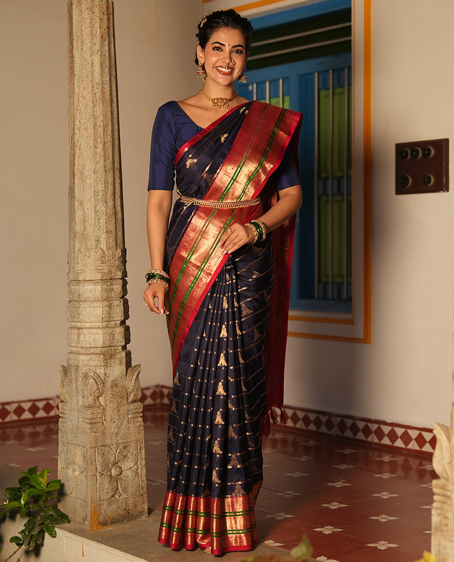 Blue Vasundhara Silk Saree, Accentuated with Zari Buttas and Stripes All Over Its Body, Complemented by a Contrast Border of Elephant, Mayil, and Chakram Designs, a Grand Pallu, and Paired with a Contrast Blouse