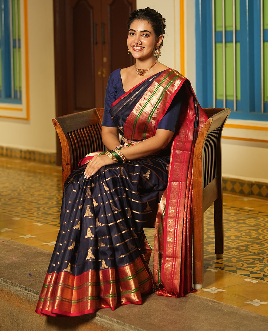 Blue Vasundhara Silk Saree, Accentuated with Zari Buttas and Stripes All Over Its Body, Complemented by a Contrast Border of Elephant, Mayil, and Chakram Designs, a Grand Pallu, and Paired with a Contrast Blouse