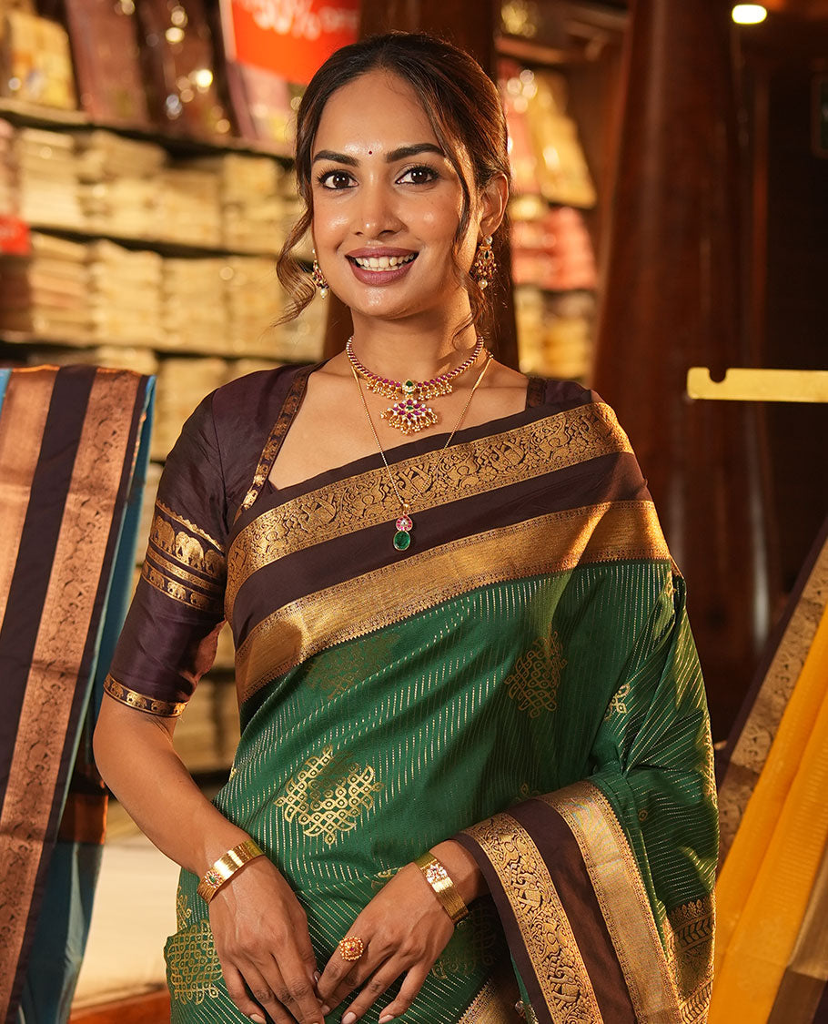 Green Budget Silk Saree, Delicately Woven with Zari Stripes and Kolam Buttas All Over Its Body, Complemented by a Contrast Traditional Zari Design Rettai Pettu Border, Grand Scallop Design Pallu, and Paired with a Contrast Blouse