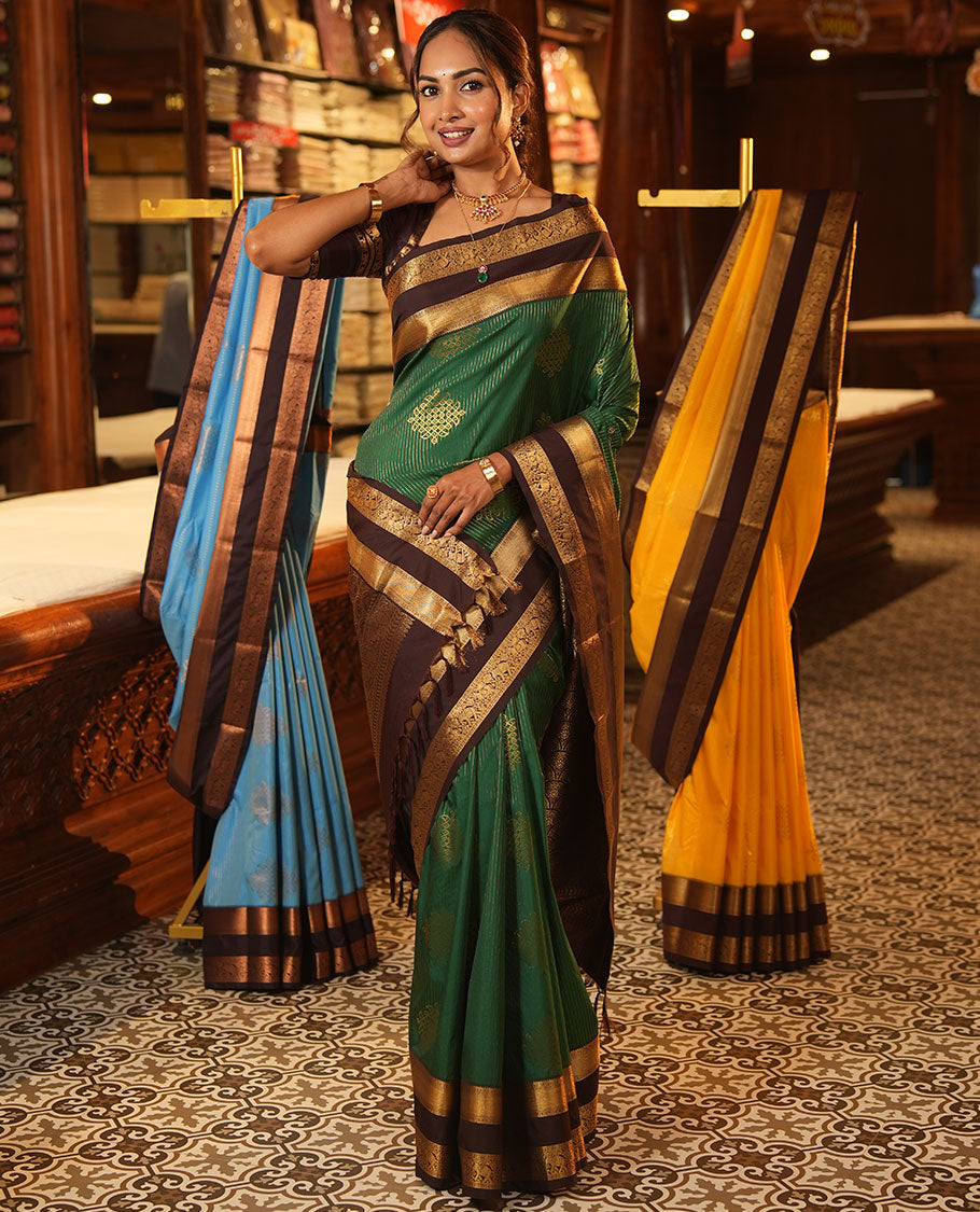 Green Budget Silk Saree, Delicately Woven with Zari Stripes and Kolam Buttas All Over Its Body, Complemented by a Contrast Traditional Zari Design Rettai Pettu Border, Grand Scallop Design Pallu, and Paired with a Contrast Blouse