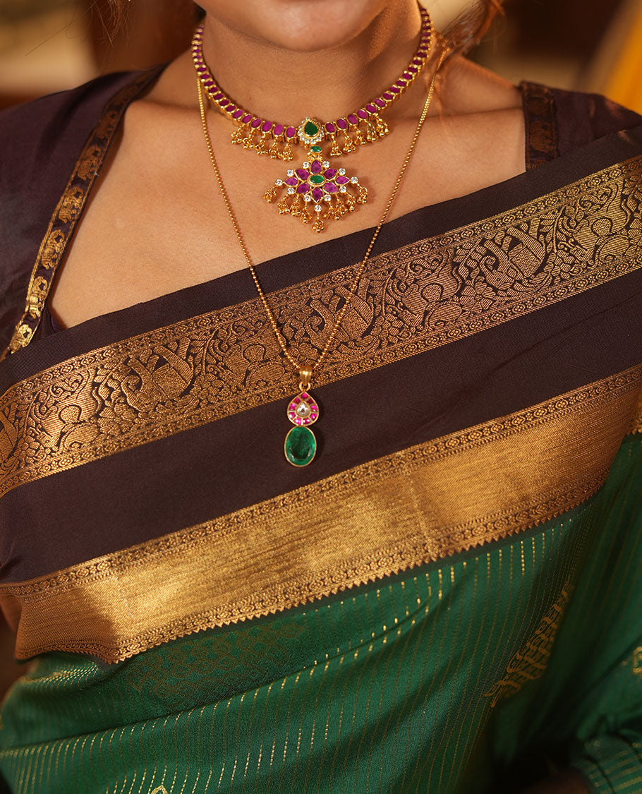 Green Budget Silk Saree, Delicately Woven with Zari Stripes and Kolam Buttas All Over Its Body, Complemented by a Contrast Traditional Zari Design Rettai Pettu Border, Grand Scallop Design Pallu, and Paired with a Contrast Blouse