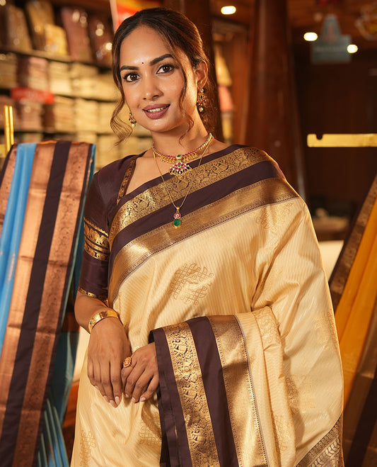Sandal Budget Silk Saree, Embellished with Zari Stripes and Kolam Buttas All Over Its Body, Complemented by a Contrast Traditional Zari Design Rettai Pettu Border, Grand Scallop Design Pallu, and Paired with a Contrast Blouse