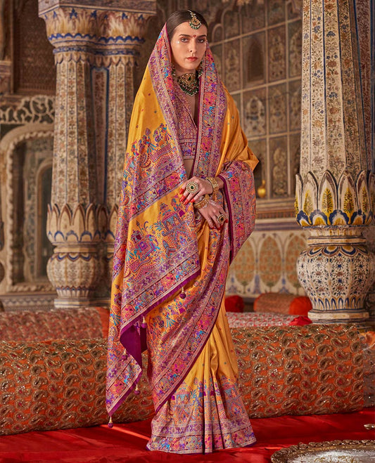 Yellow meena buttas designer catalog saree, contrast meenakari border of human and elephant motifs, and wedding theme meenakari pallu