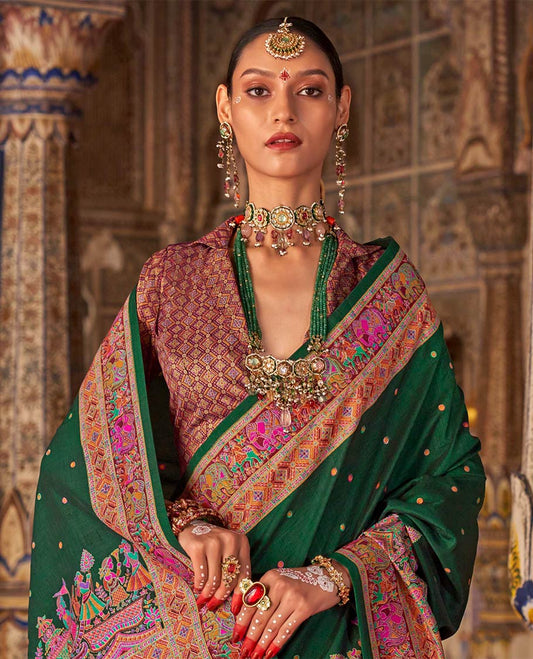 Bottle green meena buttas designer catalog saree, contrast meenakari border of human and elephant motifs, and wedding theme meenakari pallu