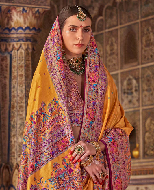 Yellow meena buttas designer catalog saree, contrast meenakari border of human and elephant motifs, and wedding theme meenakari pallu