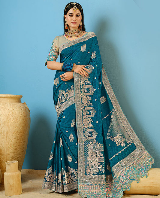 Blue Designer Saree Decorated with Buttas and Embossed Effect, Self-Border Complemented by Mughal-Inspired Motifs, Pallu of Embroidery, and a Contrast Embroidered Blouse