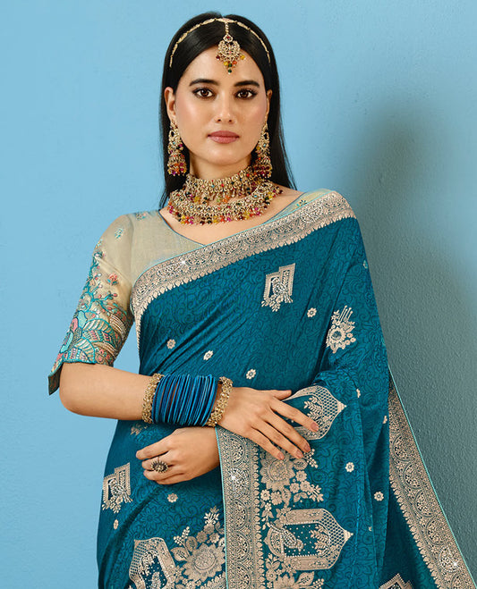 Blue Designer Saree Decorated with Buttas and Embossed Effect, Self-Border Complemented by Mughal-Inspired Motifs, Pallu of Embroidery, and a Contrast Embroidered Blouse