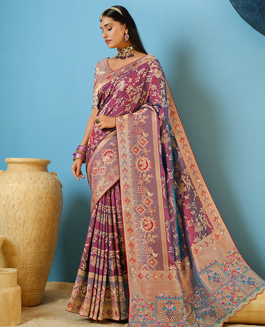 Purple Designer Saree Adorned with Floral Vine and Stonework, a Contrast Border Featuring Meenakari Design and Stonework, Pallu Depicting Floral-Peacock Motifs, and a Contrast Blouse Complemented by Embroidery