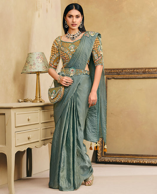 Green Plain Party Wear Designer Saree, Complemented with a Contrast Sweetheart Neck Heavy Embroidered Elbow Sleeve Readymade Blouse, Detachable Embroidered Belt, and a Free Embroidered Flap Sling Bag