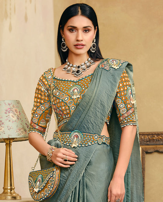Green Plain Party Wear Designer Saree, Complemented with a Contrast Sweetheart Neck Heavy Embroidered Elbow Sleeve Readymade Blouse, Detachable Embroidered Belt, and a Free Embroidered Flap Sling Bag