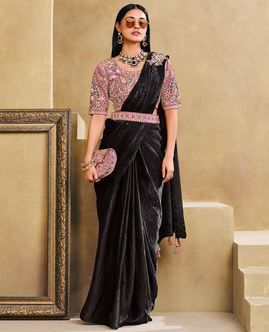 Black Plain Party Wear Designer Saree, Complemented with a Contrast Round Neck Heavy Embroidered Elbow Sleeve Readymade Blouse, Detachable Embroidered Belt, and a Free Embroidered Flap Sling Bag