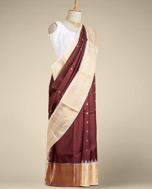 Maroon gadwal silk saree with zari buttas, contrast vidarbha zari border & pallu featuring peacock & intricate designs