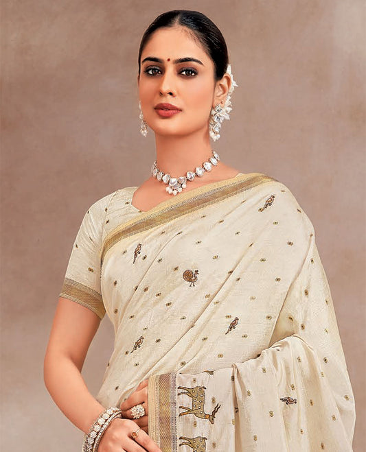Cream animal motifs designer saree, deer motifs featured on its border, and striped pallu