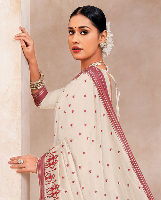 Cream buttas embroidered designer saree with warli motifs embroidery, contrast temple border and striped pallu