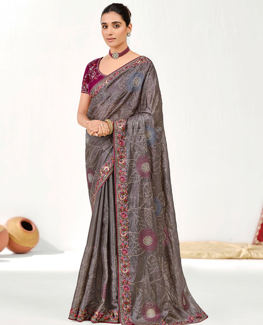 Grey Designer Saree Features Floral Embroidered and Stonework on Its Body, an Embroidered Border, a Self-Pallu, and a Contrast Embroidered Blouse