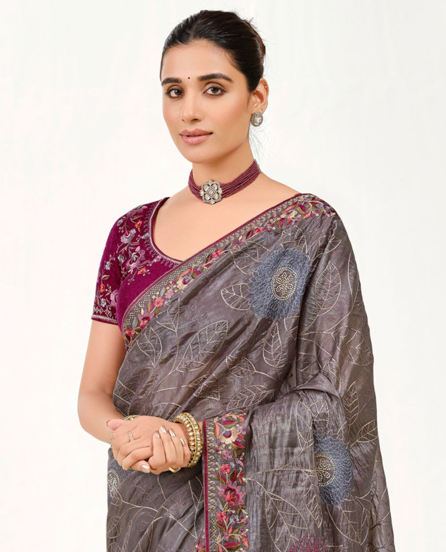 Grey Designer Saree Features Floral Embroidered and Stonework on Its Body, an Embroidered Border, a Self-Pallu, and a Contrast Embroidered Blouse