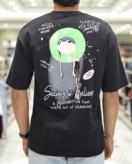 Black Glow in the Dark Cotton-Blended T-Shirt, Bedecked with Colorful Cartoon Motifs Print, Comes with a Crew Neck, Half-Sleeves, Oversized Fit, and Long Length