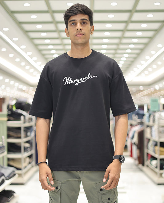 Black Glow in the Dark Cotton-Blended T-Shirt, Accentuated with Colorful Cartoon Motifs Print, Comes with a Crew Neck, Half-Sleeves, Oversized Fit, and Long Length