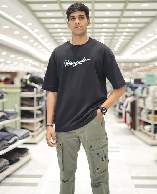 Black Glow in the Dark Cotton-Blended T-Shirt, Accentuated with Colorful Cartoon Motifs Print, Comes with a Crew Neck, Half-Sleeves, Oversized Fit, and Long Length