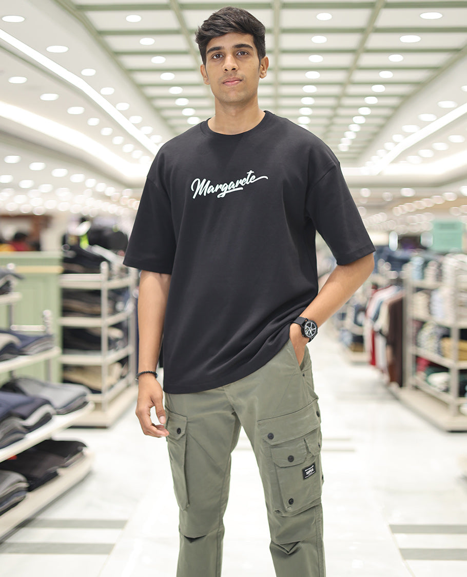 Black Glow in the Dark Cotton-Blended T-Shirt, Accentuated with Colorful Cartoon Motifs Print, Comes with a Crew Neck, Half-Sleeves, Oversized Fit, and Long Length