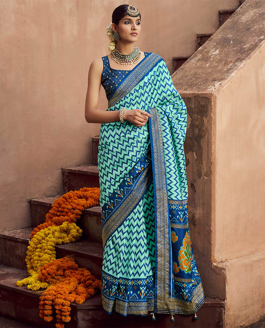 Turquoise Ikat Patola Designer Saree, Adorned with Ikat Chevron Stripes, Complemented by a Contrast Ikat Border, Ikat Woven Pallu, and a Contrast Blouse