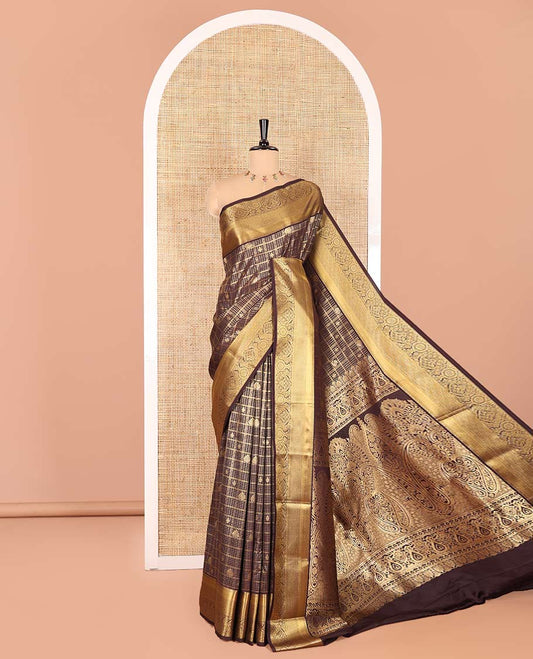 Brown Kanchipuram budget silk saree enriched with zari butta enclosed checks all over its body, complemented by zari traditional design border, Mughal-style intricate pallu, and paired with a Matching blouse