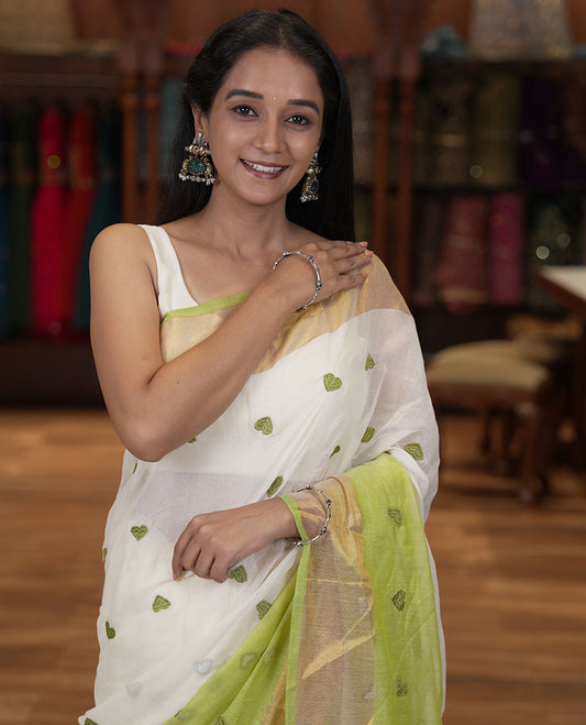 Cream and Pista Green Khadi Mul Cotton Saree, Adorned with Half-And-Half-Style and Heart Motifs Embroidery on Its Body, a Subtle Gold Zari Border, a Self-Pallu, and Has No Blouse