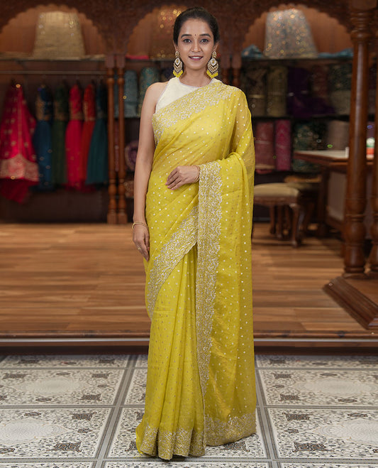 Yellow Fendi Chiffon Saree, Steeped with 1000-Buttas All Over Its Body, Highlighted by a Scallop Embroidered Border, a Self-Pallu, and Paired with a Matching Blouse